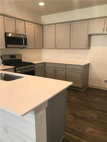 a kitchen with granite countertop a stove and a sink