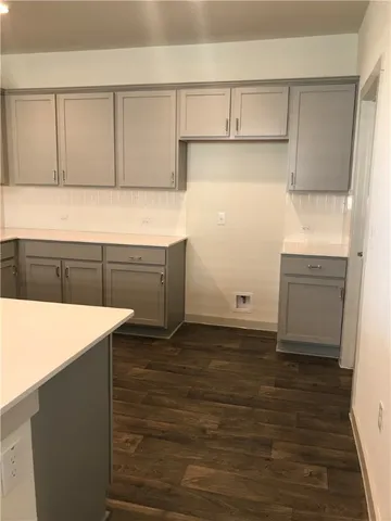 a kitchen with granite countertop white cabinets and white appliances