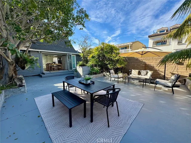a backyard of a house with barbeque oven table and chairs