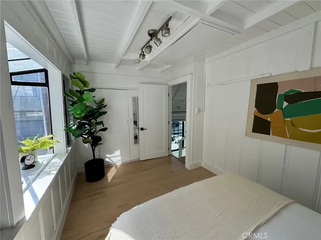 a bedroom with a bed potted plant and a window