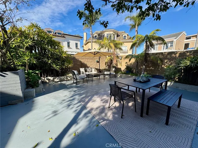 a view of a patio with table and chairs and potted plants