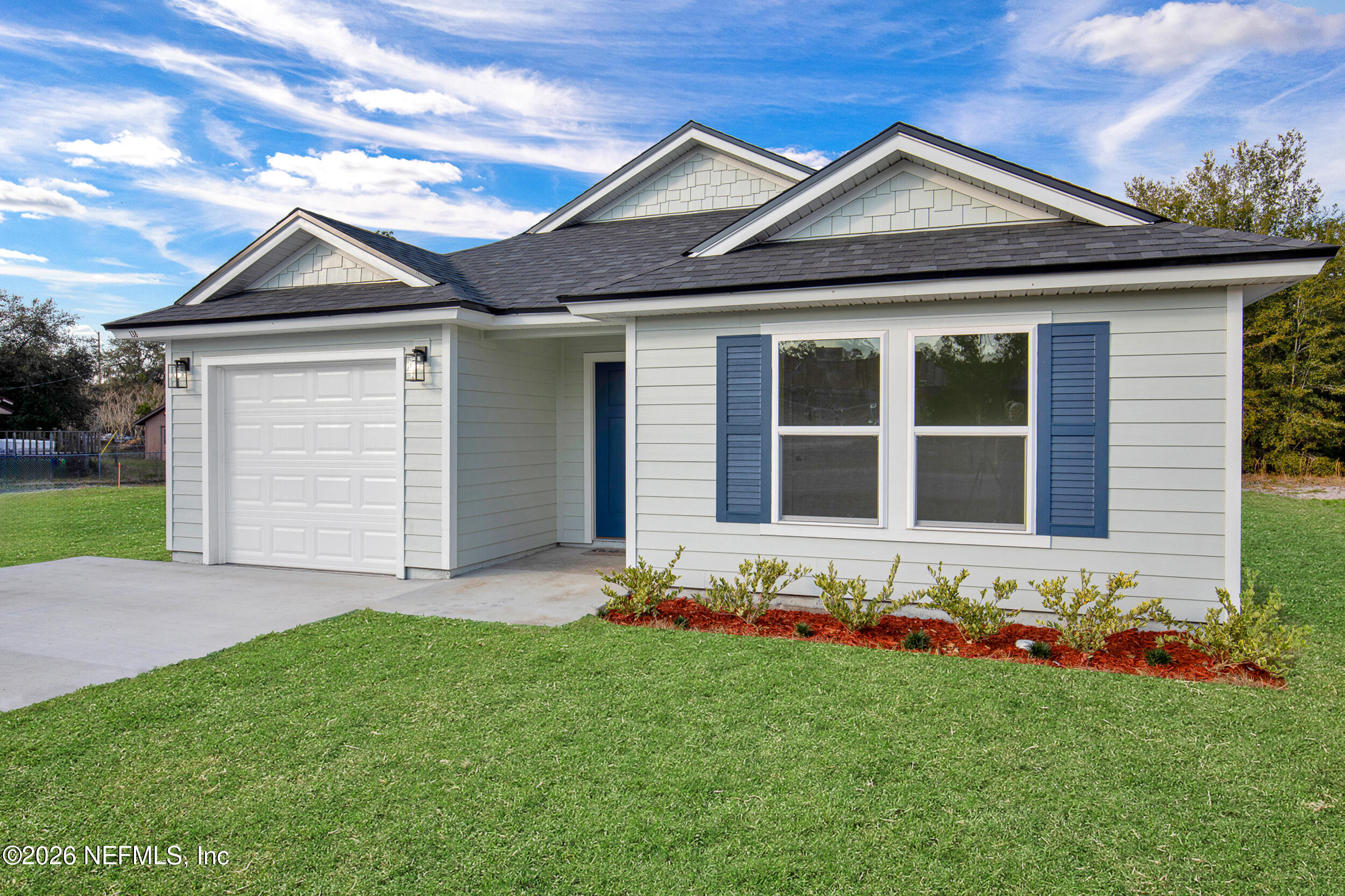 a front view of a house with a garden