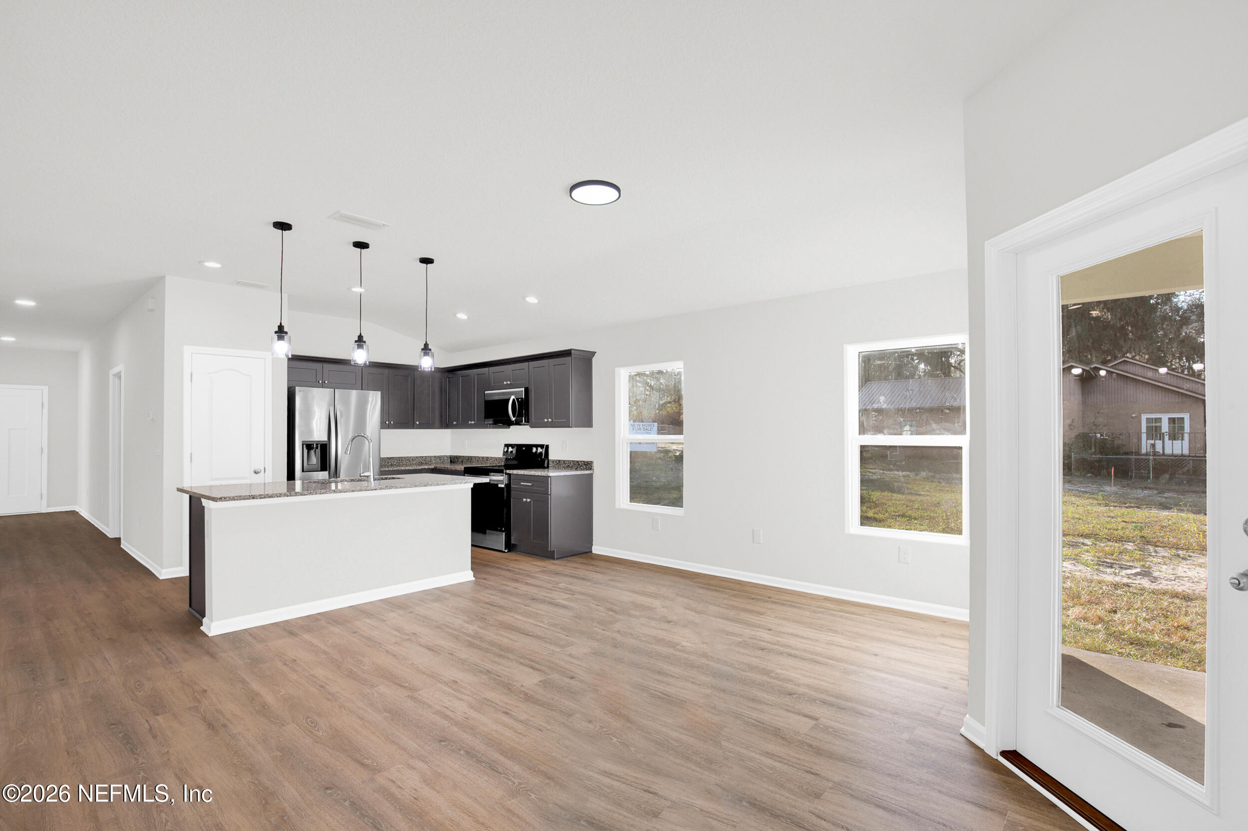 138 Kelly Smith School Road Palatka, FL 32177 - Photo 12 of 52 a view of kitchen with stainless steel appliances kitchen island wooden floors and living room view