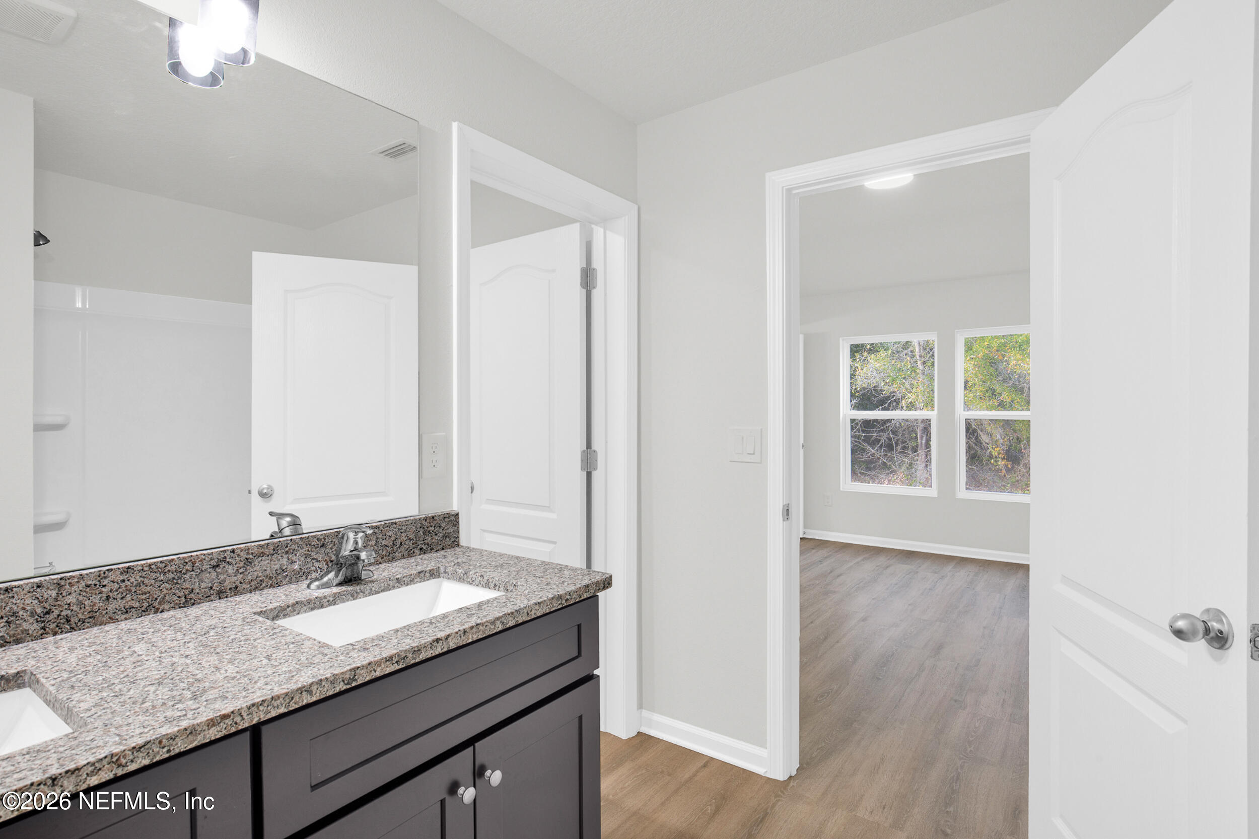 138 Kelly Smith School Road Palatka, FL 32177 - Photo 23 of 52 a bathroom with a granite countertop sink and a mirror