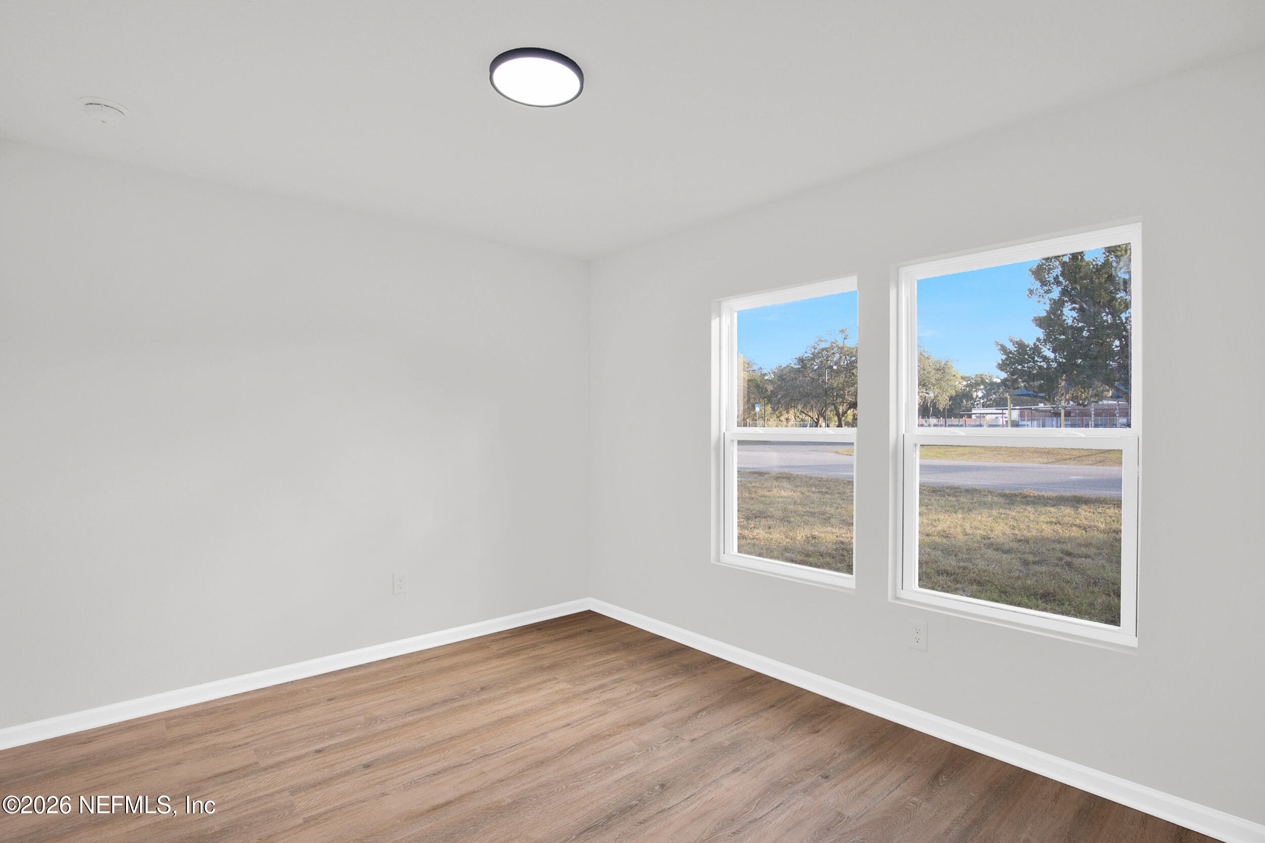 138 Kelly Smith School Road Palatka, FL 32177 - Photo 34 of 52 an empty room with wooden floor and windows
