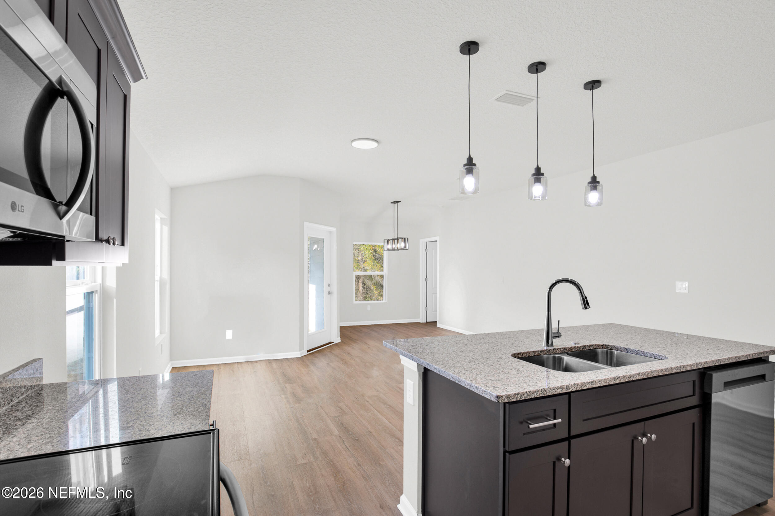 138 Kelly Smith School Road Palatka, FL 32177 - Photo 7 of 52 a kitchen with kitchen island a sink stainless steel appliances and wooden floor