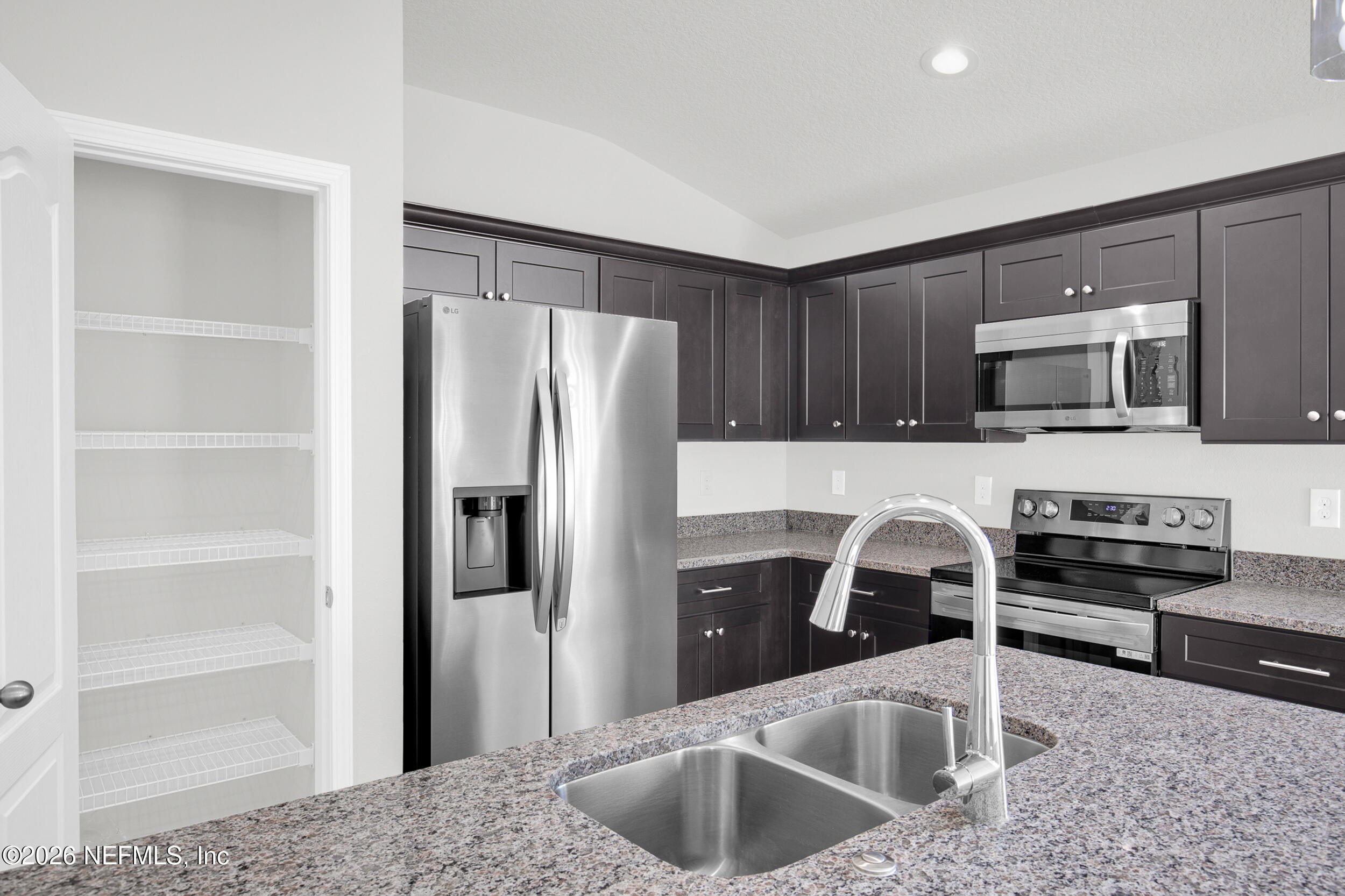 138 Kelly Smith School Road Palatka, FL 32177 - Photo 8 of 52 a kitchen with stainless steel appliances granite countertop a refrigerator a stove and a sink with wooden cabinets