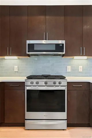 a kitchen with granite countertop a stove and a sink