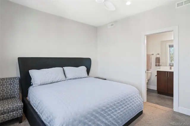 a bedroom with a bed and a couch