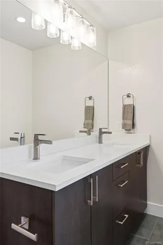 a bathroom with a sink a vanity and a mirror