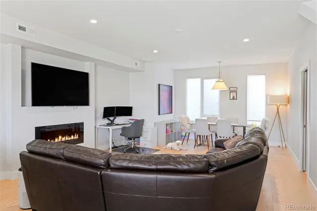a living room with fireplace furniture and a flat screen tv
