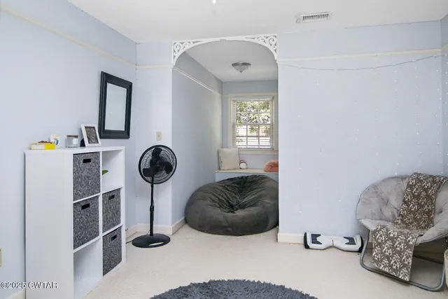 a bedroom with furniture and a window