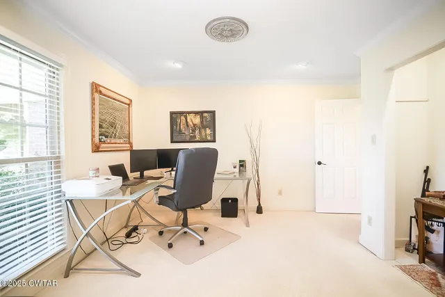 a work room with furniture and a window
