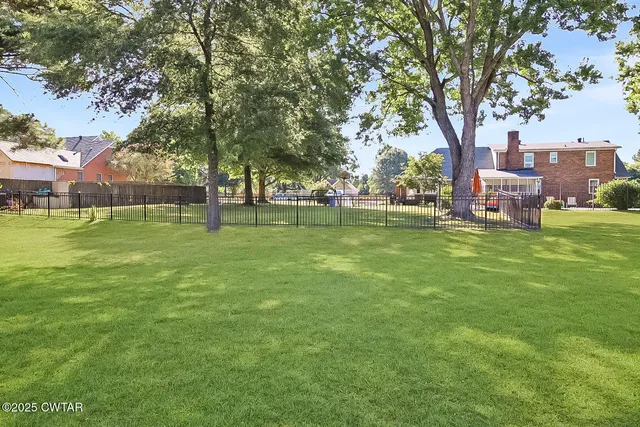 a view of a park with large trees