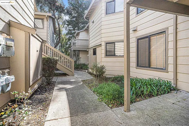 a view of a house with brick walls and a small yard