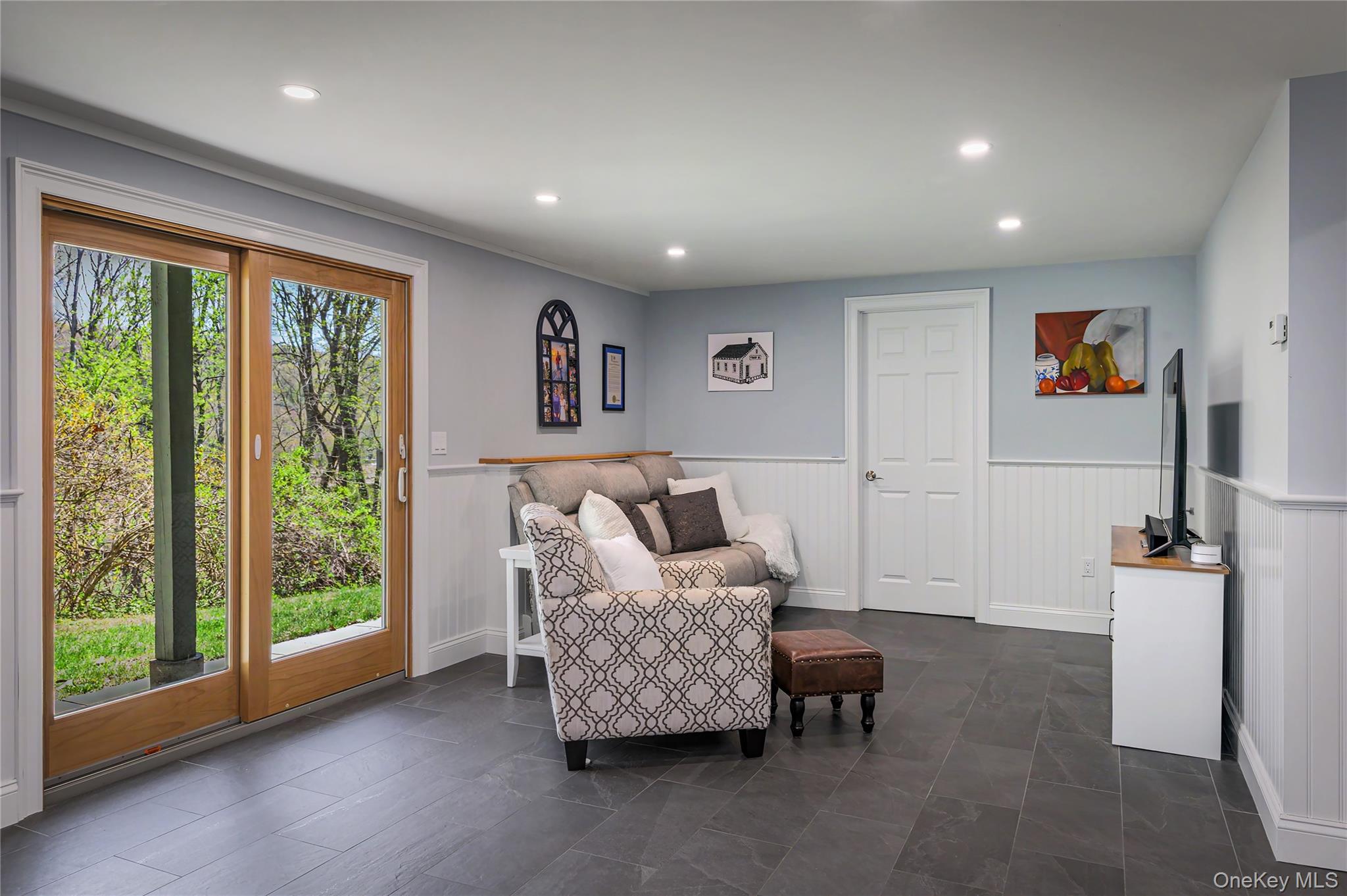 41 Cross Pond Road Pound Ridge, NY 10576 - Photo 32 of 41 a living room with furniture and a flat screen tv