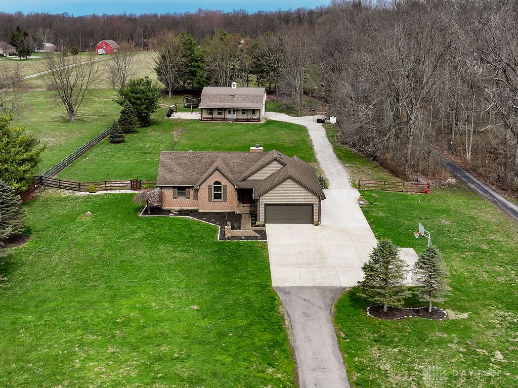 7400 Cook-Jones Road Waynesville, OH 45068 - Photo 15 of 72 This spacious property features a charming main residence and an additional structure, surrounded by lush green lawns.