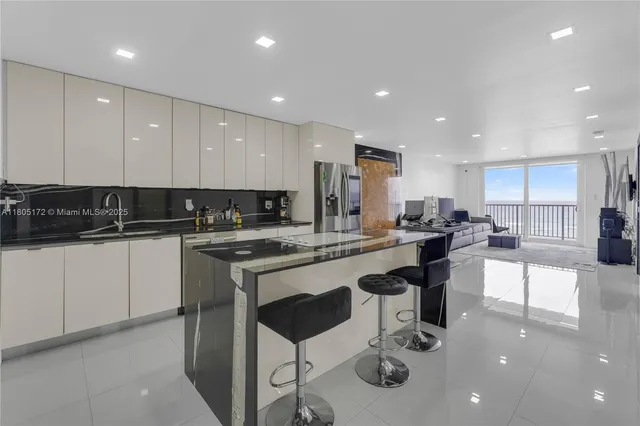 a kitchen with a sink cabinets and chairs