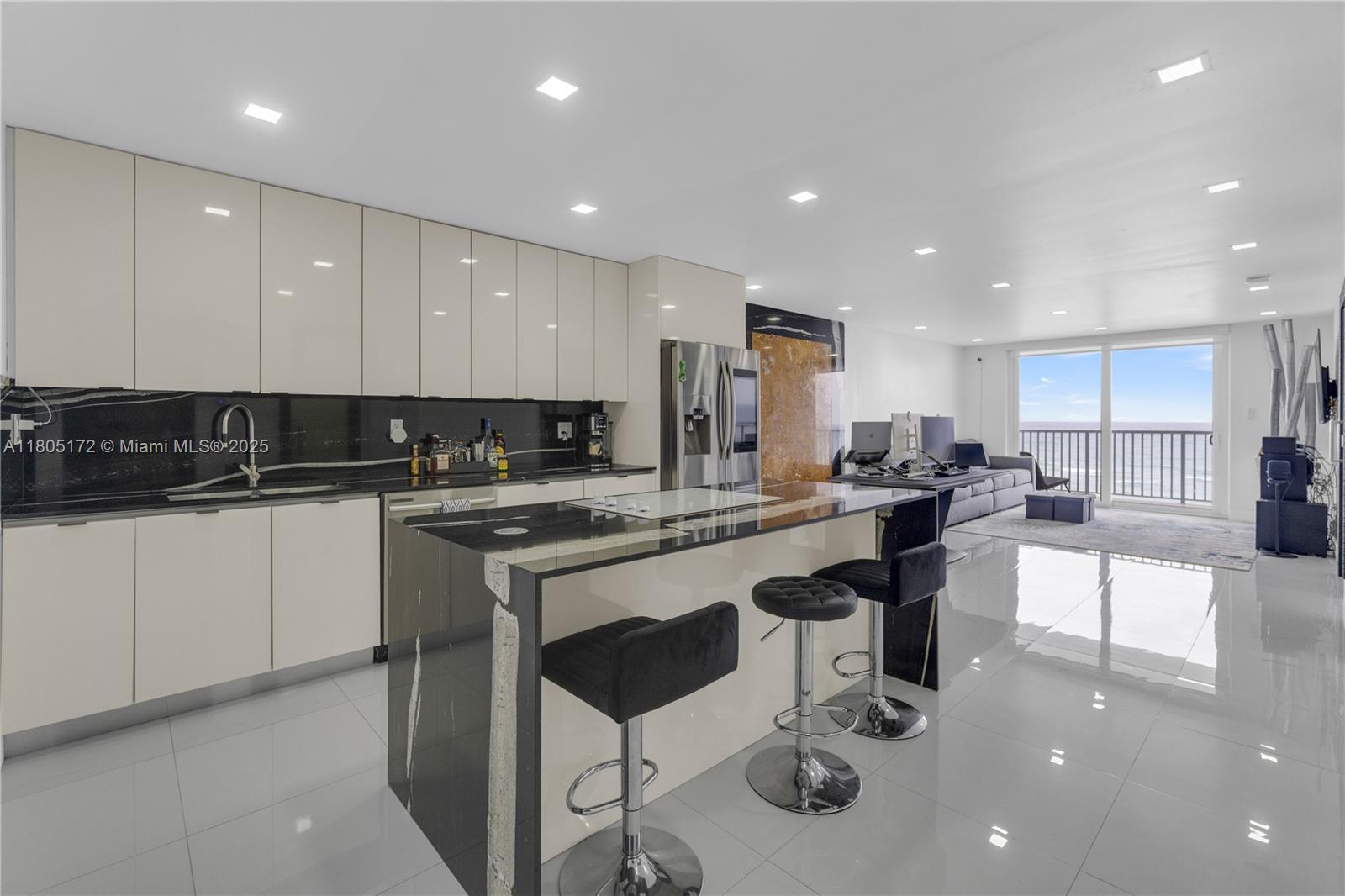 400 North Surf Road, Unit 504 Hollywood, FL 33019 - Photo 1 of 44 a kitchen with a sink cabinets and chairs