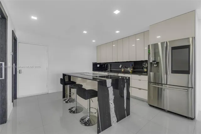 a kitchen with stainless steel appliances granite countertop a refrigerator sink and cabinets