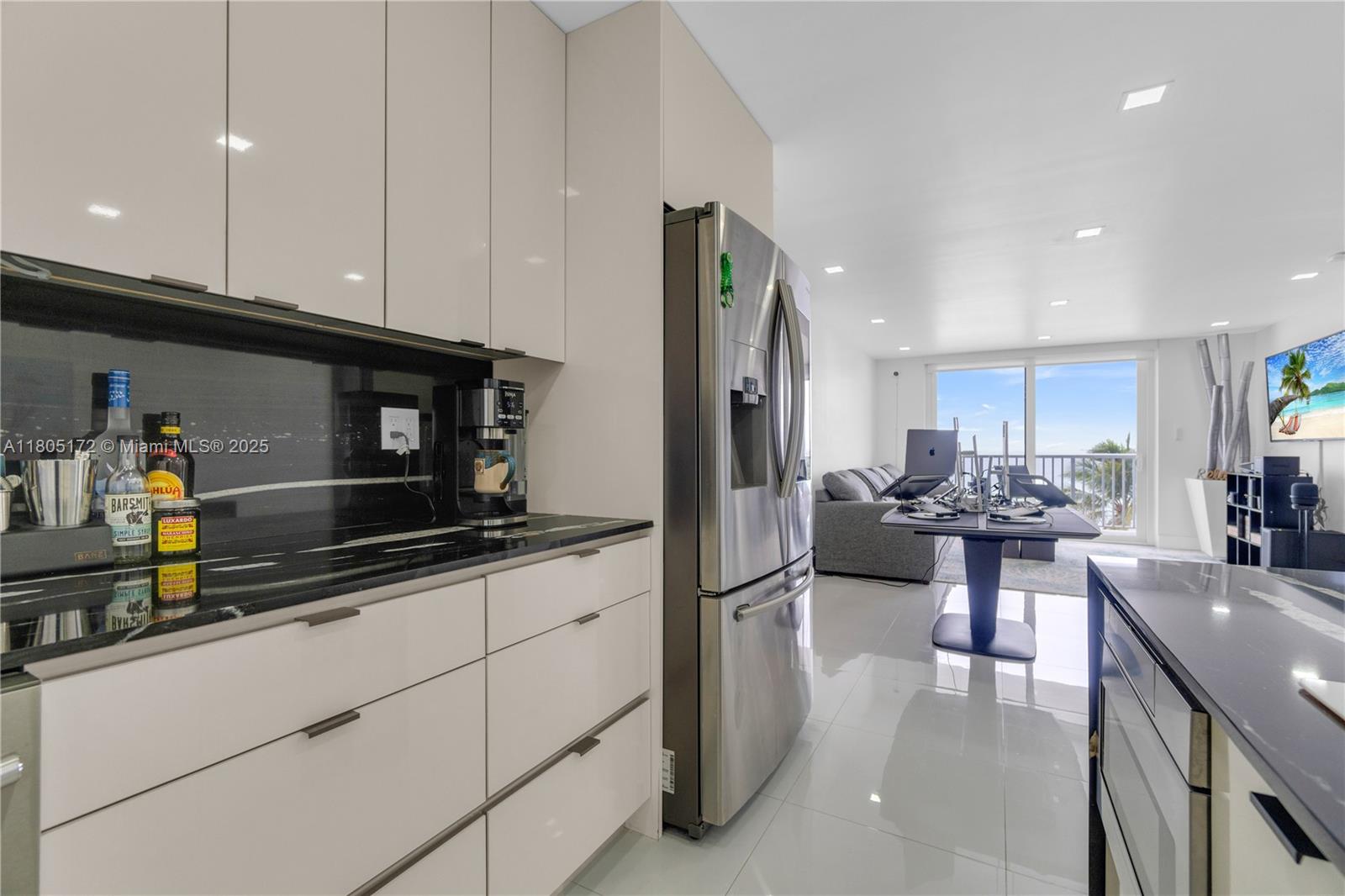 400 North Surf Road, Unit 504 Hollywood, FL 33019 - Photo 19 of 44 a kitchen with stainless steel appliances kitchen island granite countertop a refrigerator and a stove top oven