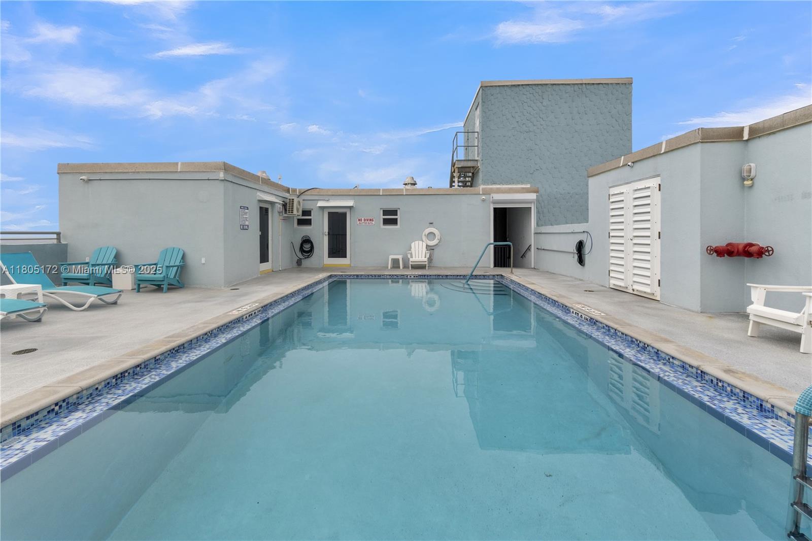 400 North Surf Road, Unit 504 Hollywood, FL 33019 - Photo 25 of 44 a large white kitchen with kitchen island granite countertop a sink and white cabinets