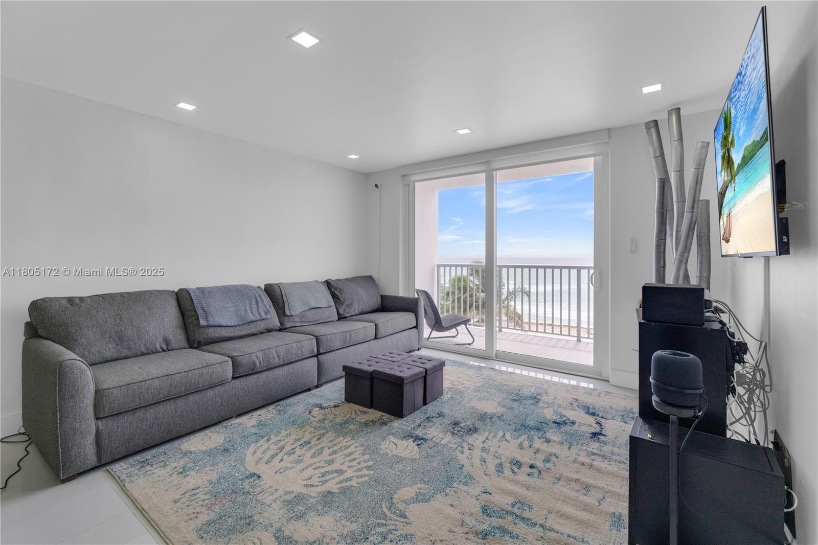 400 North Surf Road, Unit 504 Hollywood, FL 33019 - Photo 4 of 44 a living room with furniture and a flat screen tv