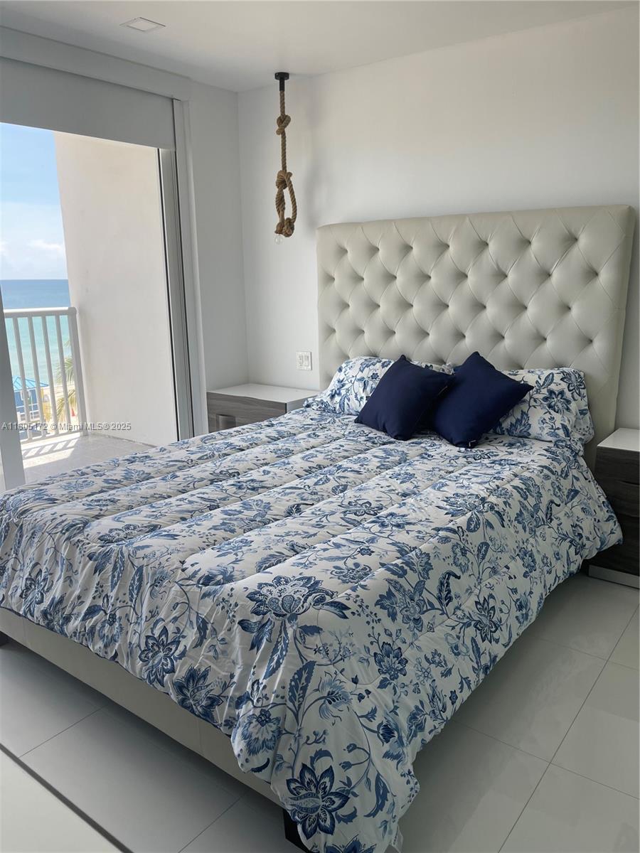 400 North Surf Road, Unit 504 Hollywood, FL 33019 - Photo 42 of 44 a bedroom with a bed and a chair