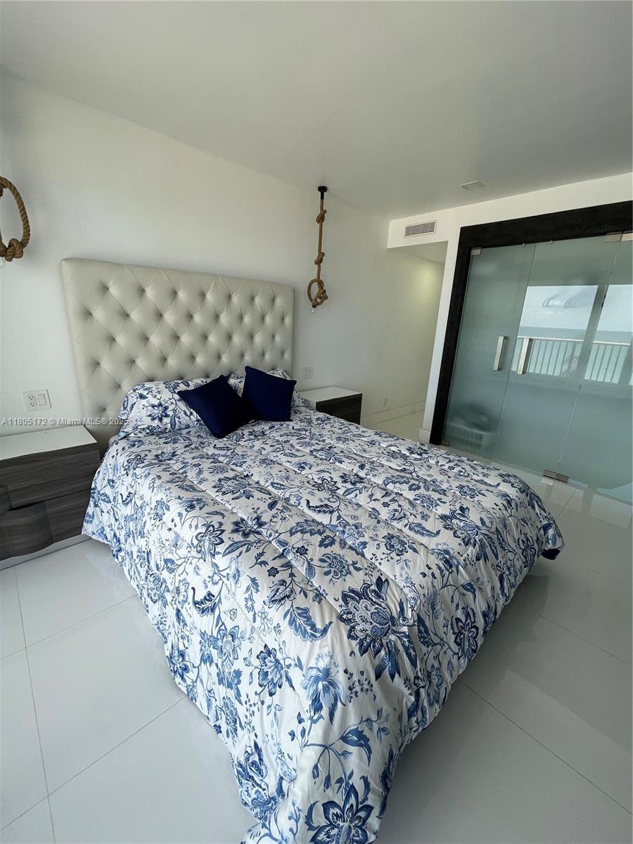 400 North Surf Road, Unit 504 Hollywood, FL 33019 - Photo 44 of 44 a bedroom with a bed and a mirror