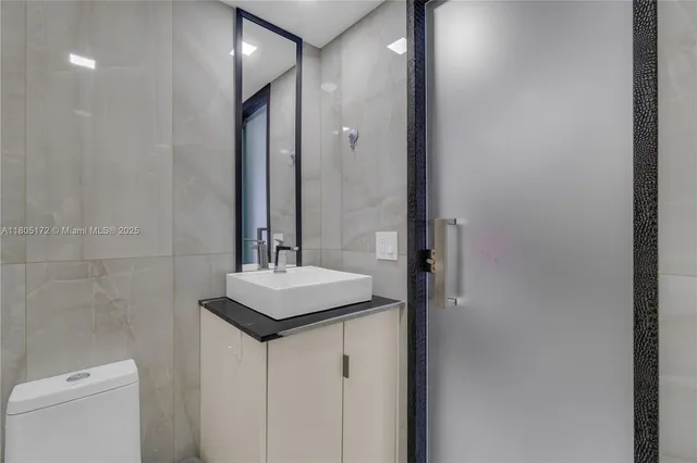 a kitchen with a refrigerator and chairs