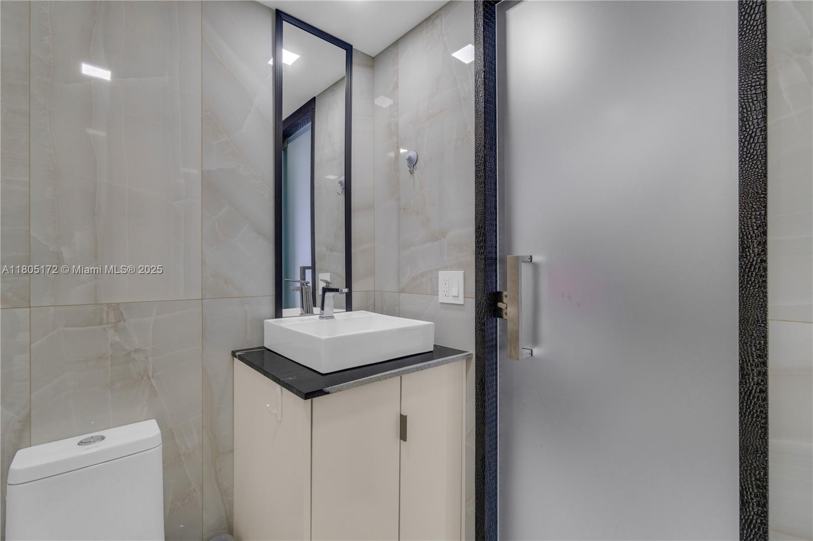 400 North Surf Road, Unit 504 Hollywood, FL 33019 - Photo 9 of 44 a bathroom with a sink a toilet and shower