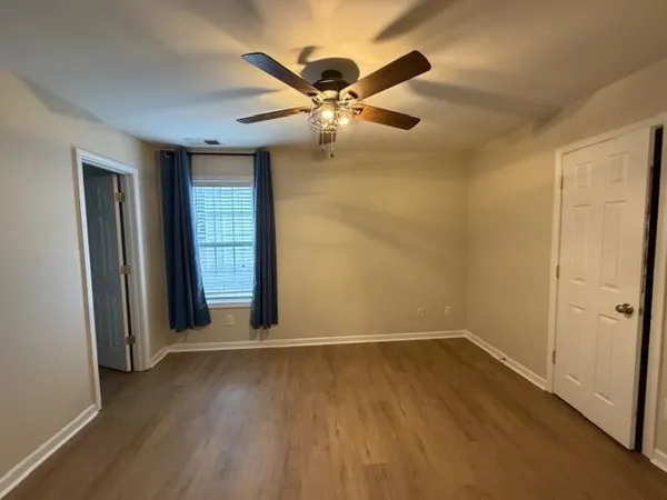 wooden floor in an empty room with a window