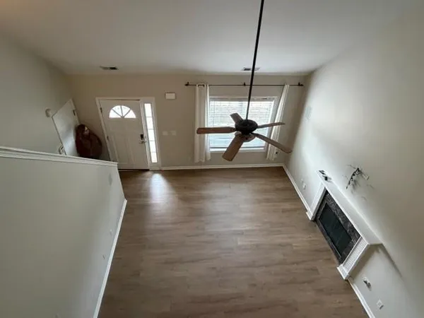 a view of a room with wooden floor