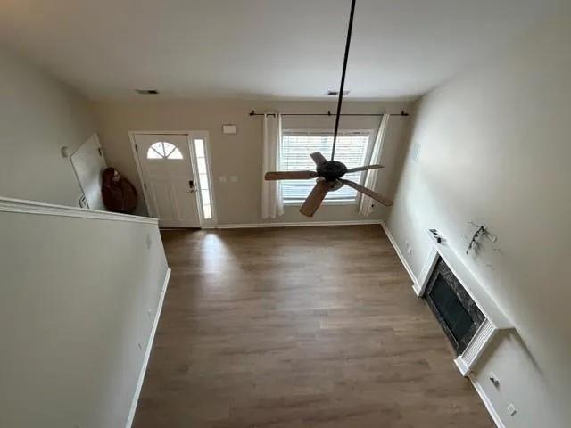 a view of a room with wooden floor