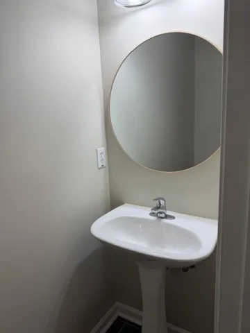 a bathroom with a sink and mirror