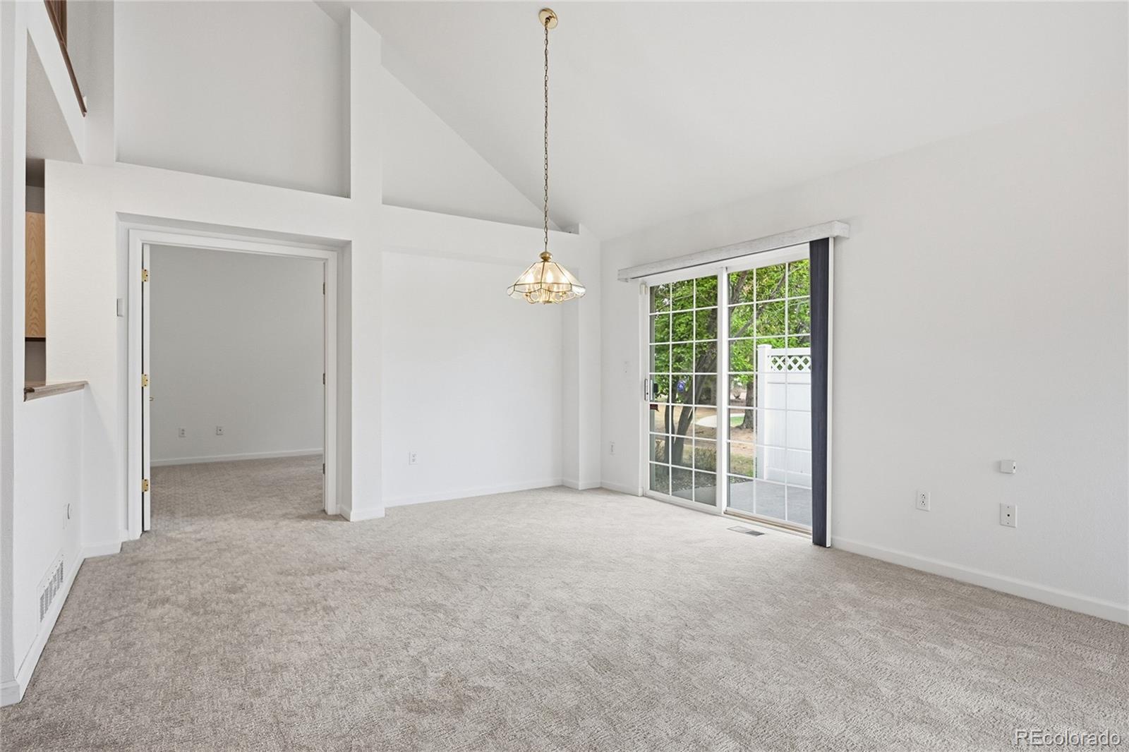 6383 Deframe Way Arvada, CO 80004 - Photo 12 of 49 en empty room with windows and ceiling fan