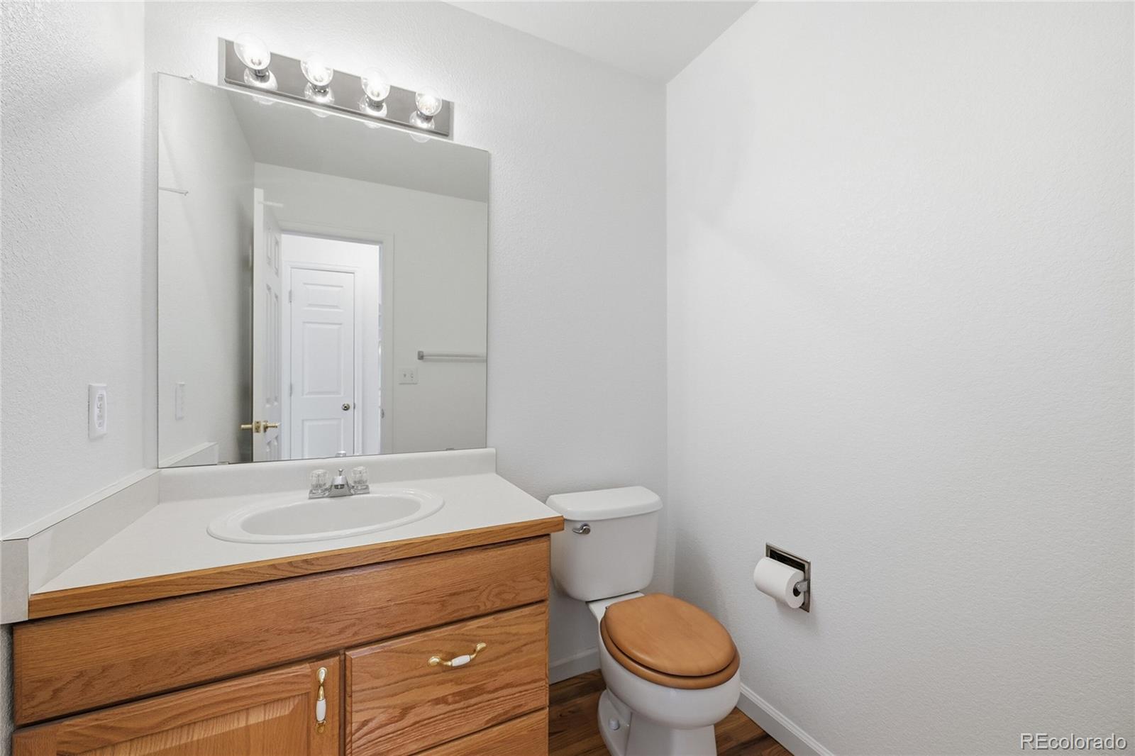 6383 Deframe Way Arvada, CO 80004 - Photo 17 of 49 a bathroom with a sink a toilet and mirror