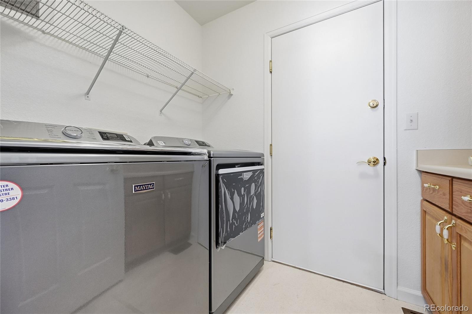 6383 Deframe Way Arvada, CO 80004 - Photo 18 of 49 a utility room with dryer and washer