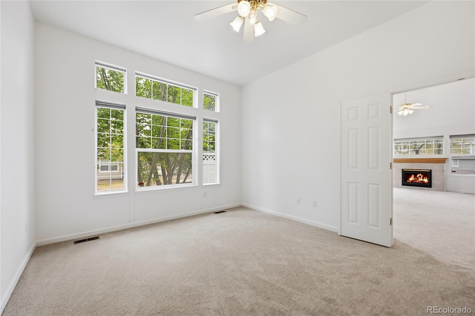 6383 Deframe Way Arvada, CO 80004 - Photo 20 of 49 an empty room with a fireplace and a window