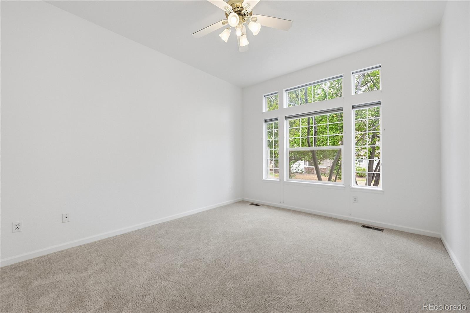 6383 Deframe Way Arvada, CO 80004 - Photo 23 of 49 an empty room with a window and a ceiling fan