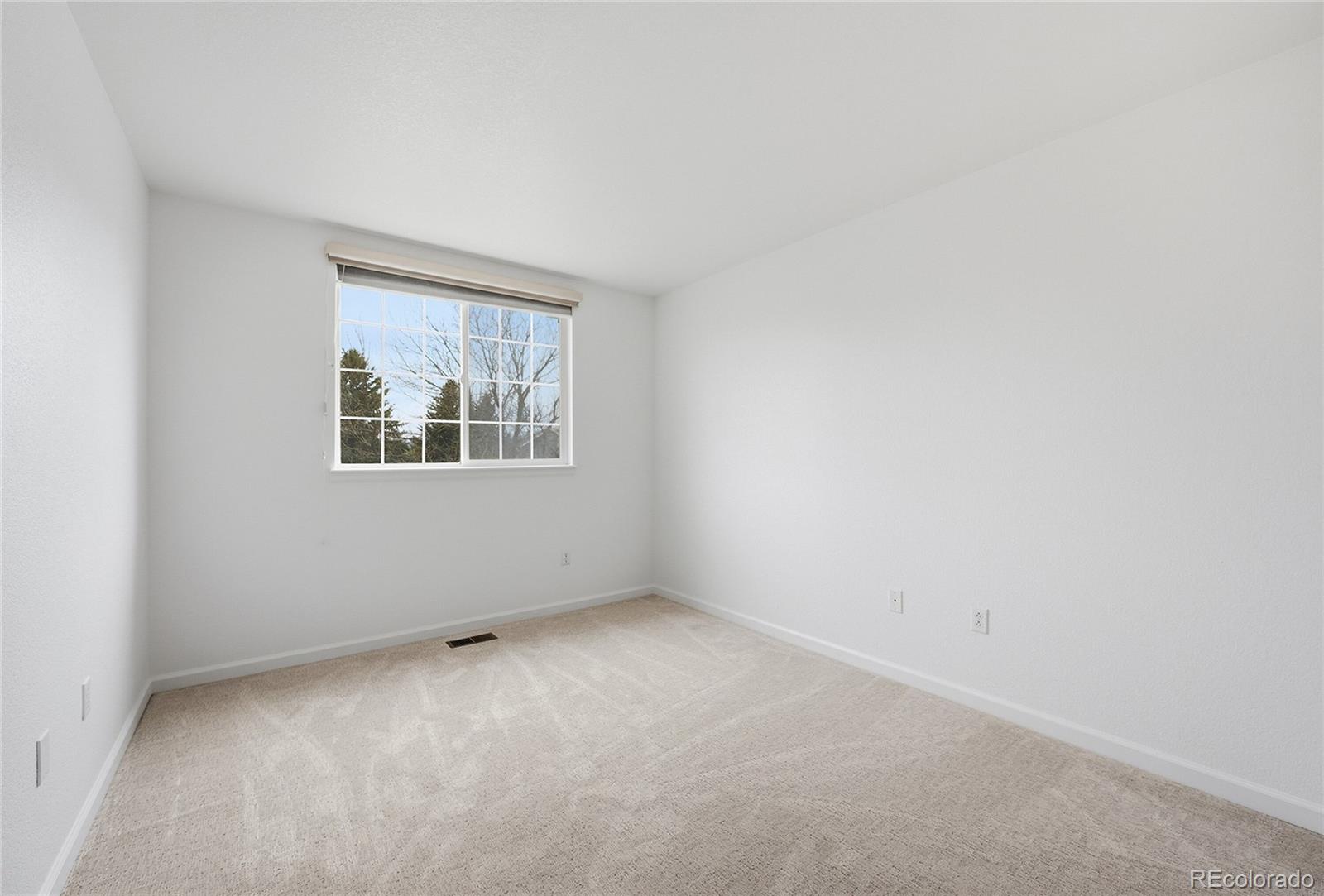 6383 Deframe Way Arvada, CO 80004 - Photo 25 of 49 an empty room with windows