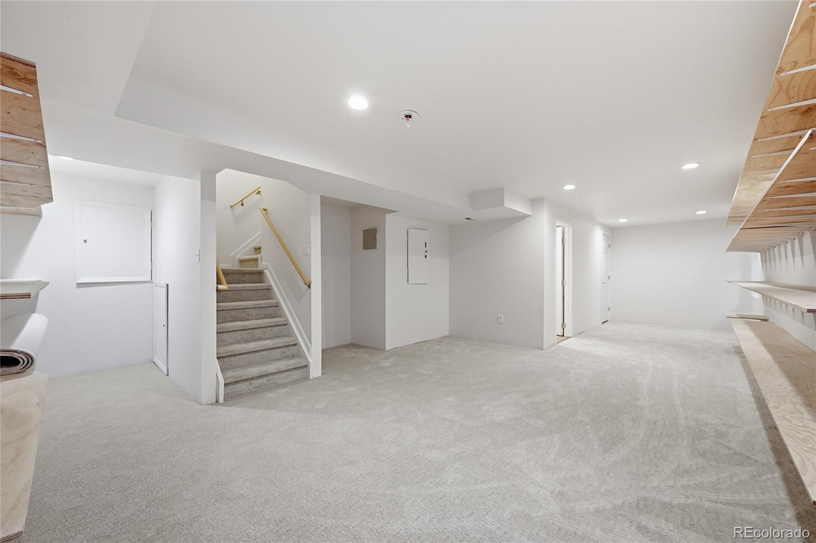 6383 Deframe Way Arvada, CO 80004 - Photo 31 of 49 a view of an empty room with wooden floor and stairs
