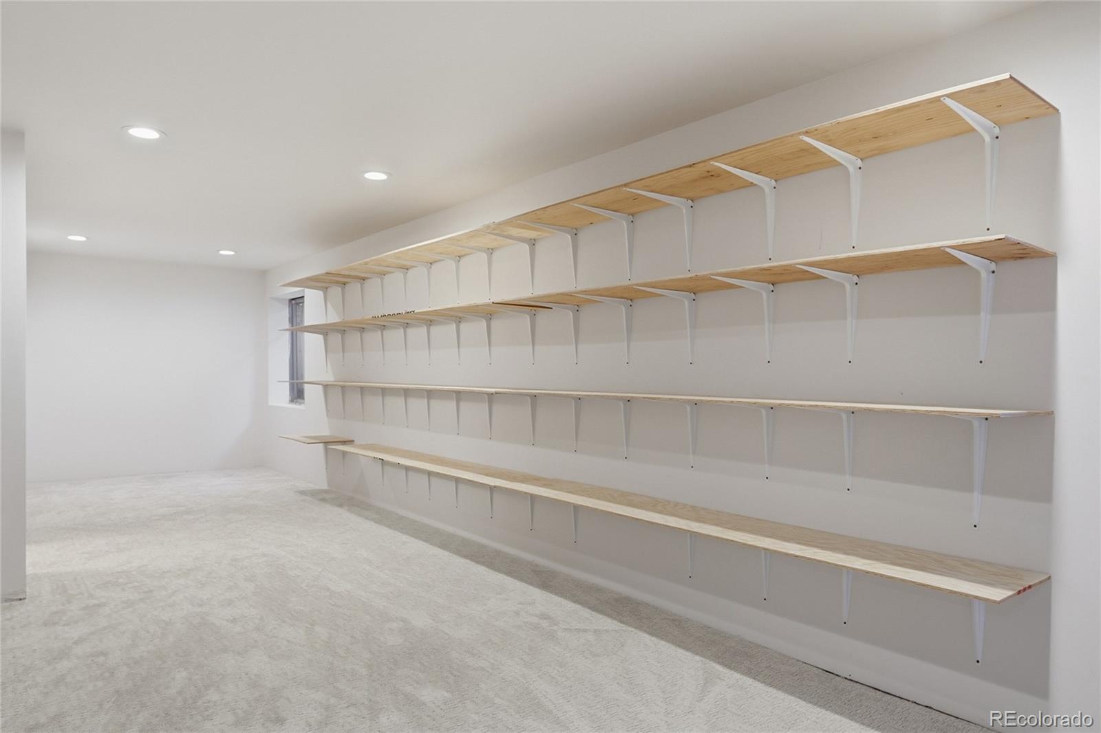 6383 Deframe Way Arvada, CO 80004 - Photo 32 of 49 a view of walk in closet with empty racks