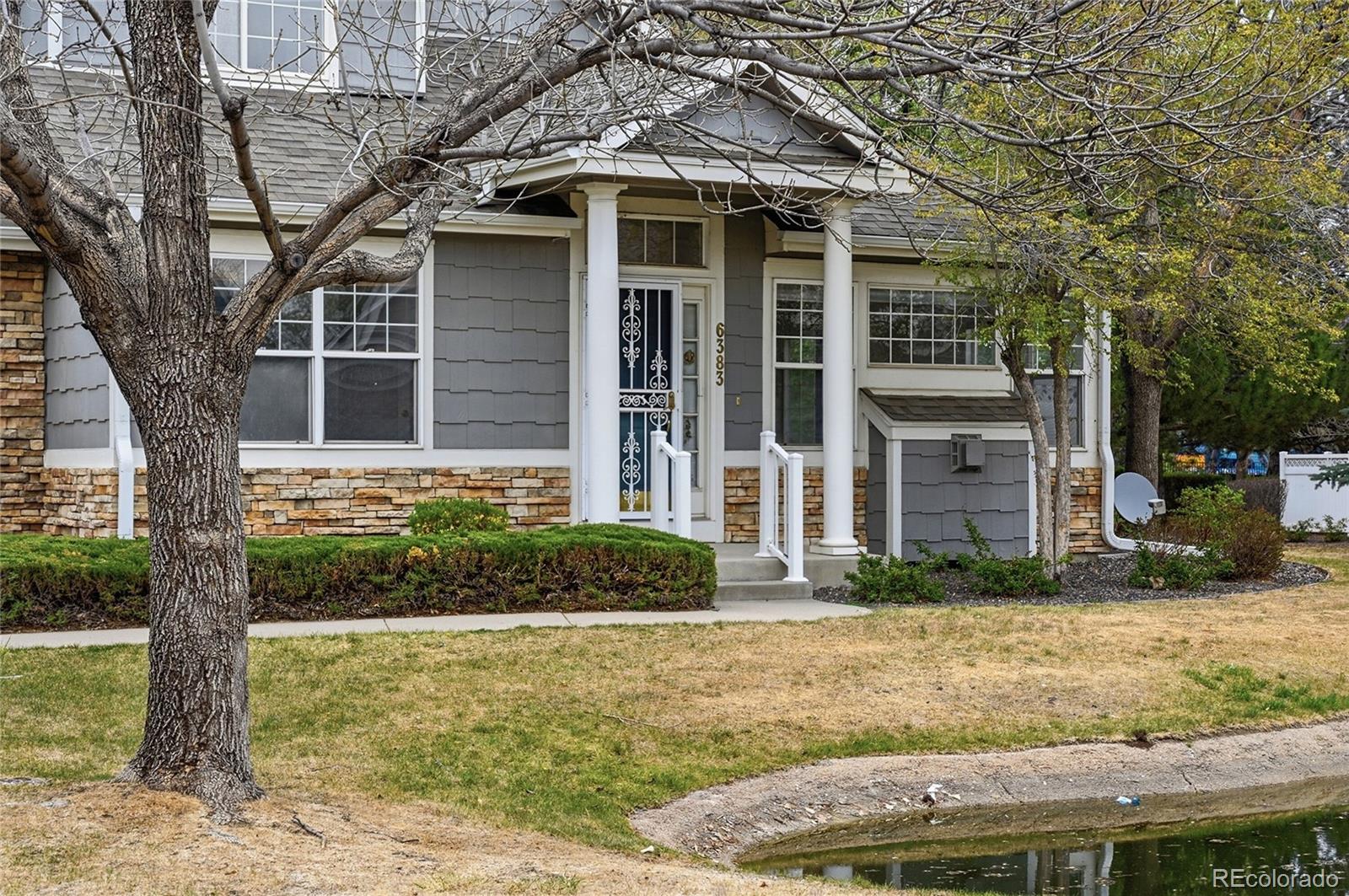 6383 Deframe Way Arvada, CO 80004 - Photo 36 of 49 a front view of a house with garden