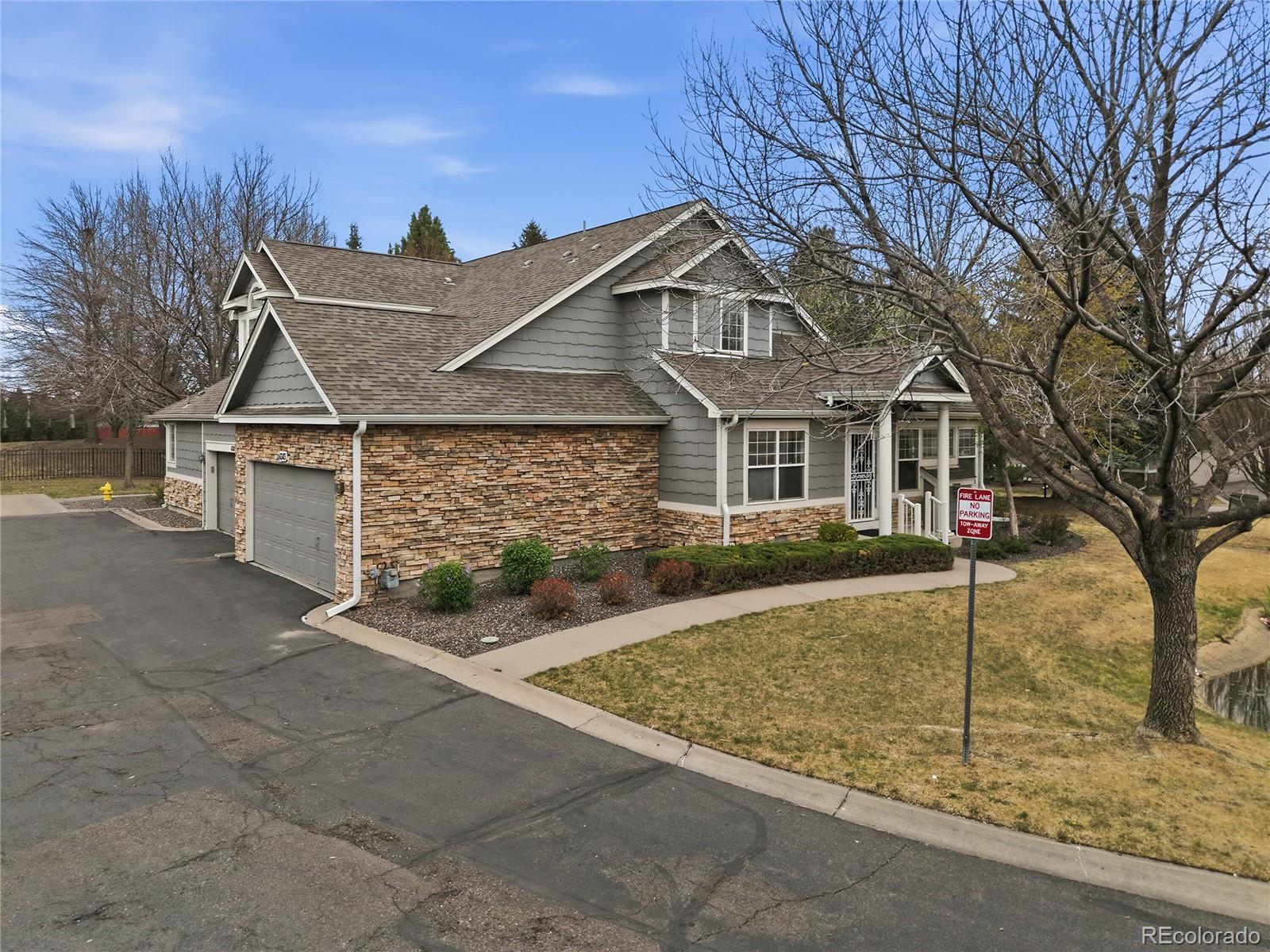 6383 Deframe Way Arvada, CO 80004 - Photo 45 of 49 a front view of a house with a garden