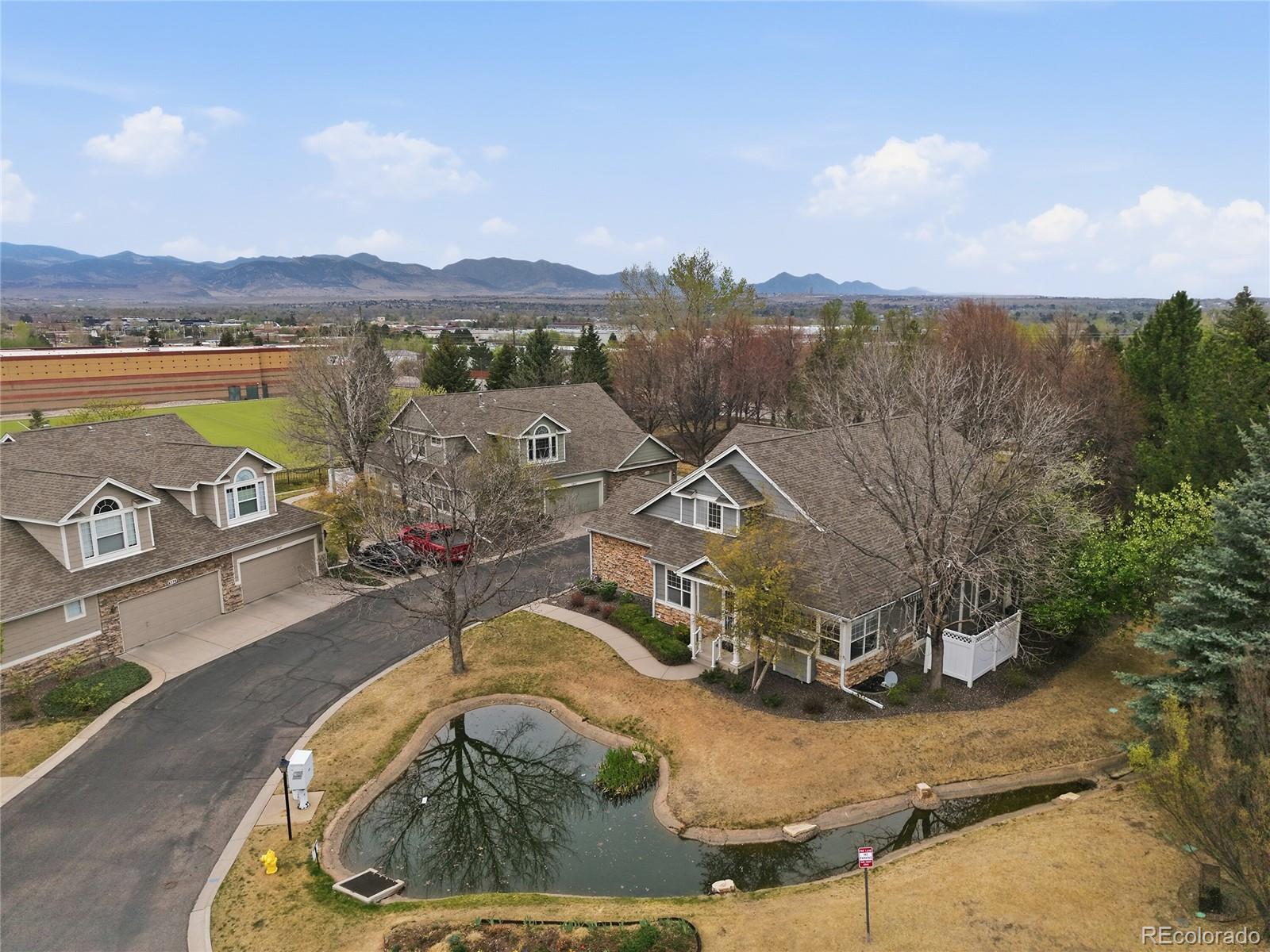 6383 Deframe Way Arvada, CO 80004 - Photo 46 of 49 an aerial view of a house with outdoor space and a lake view