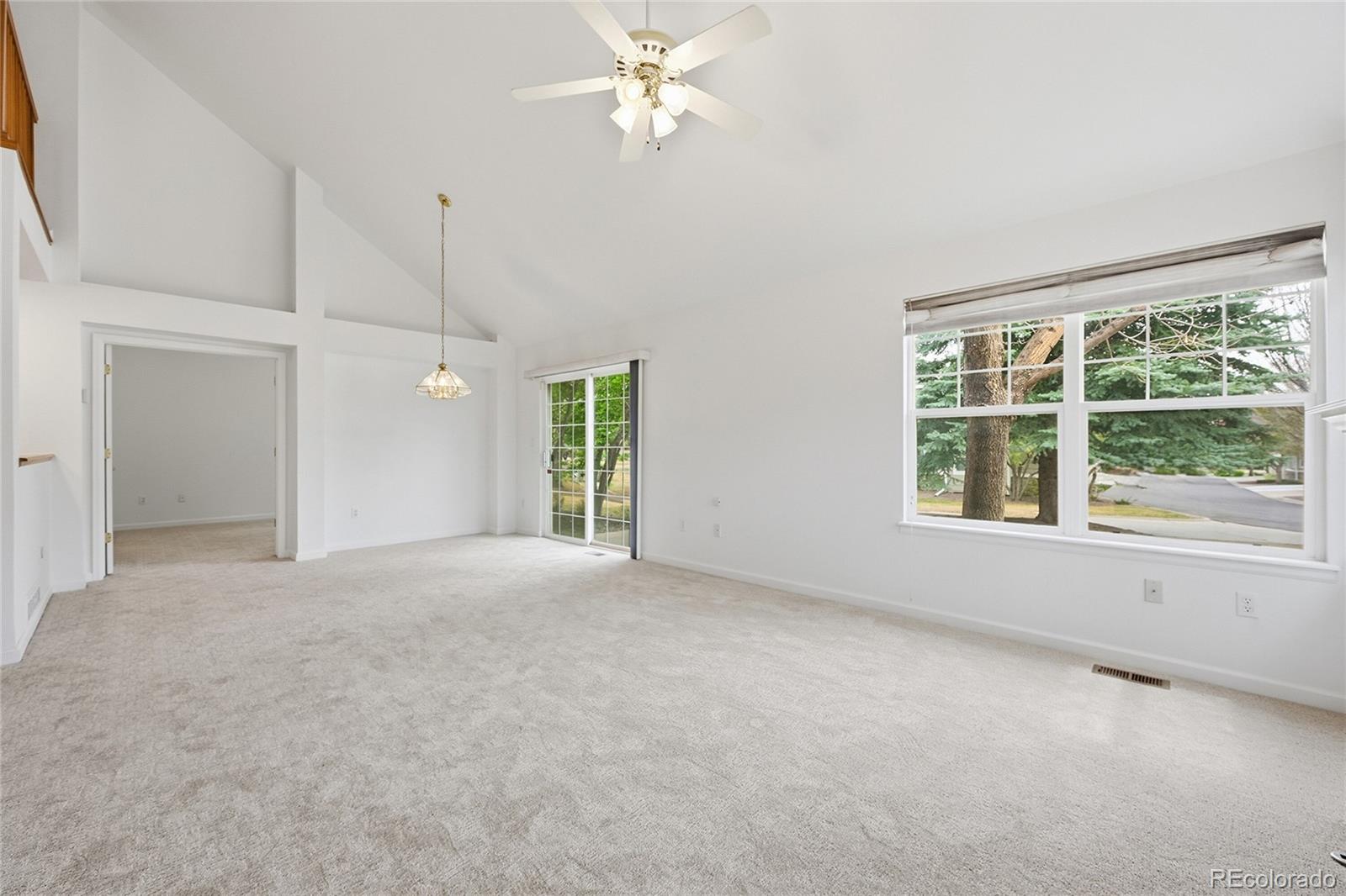 6383 Deframe Way Arvada, CO 80004 - Photo 7 of 49 an empty room with windows and fan