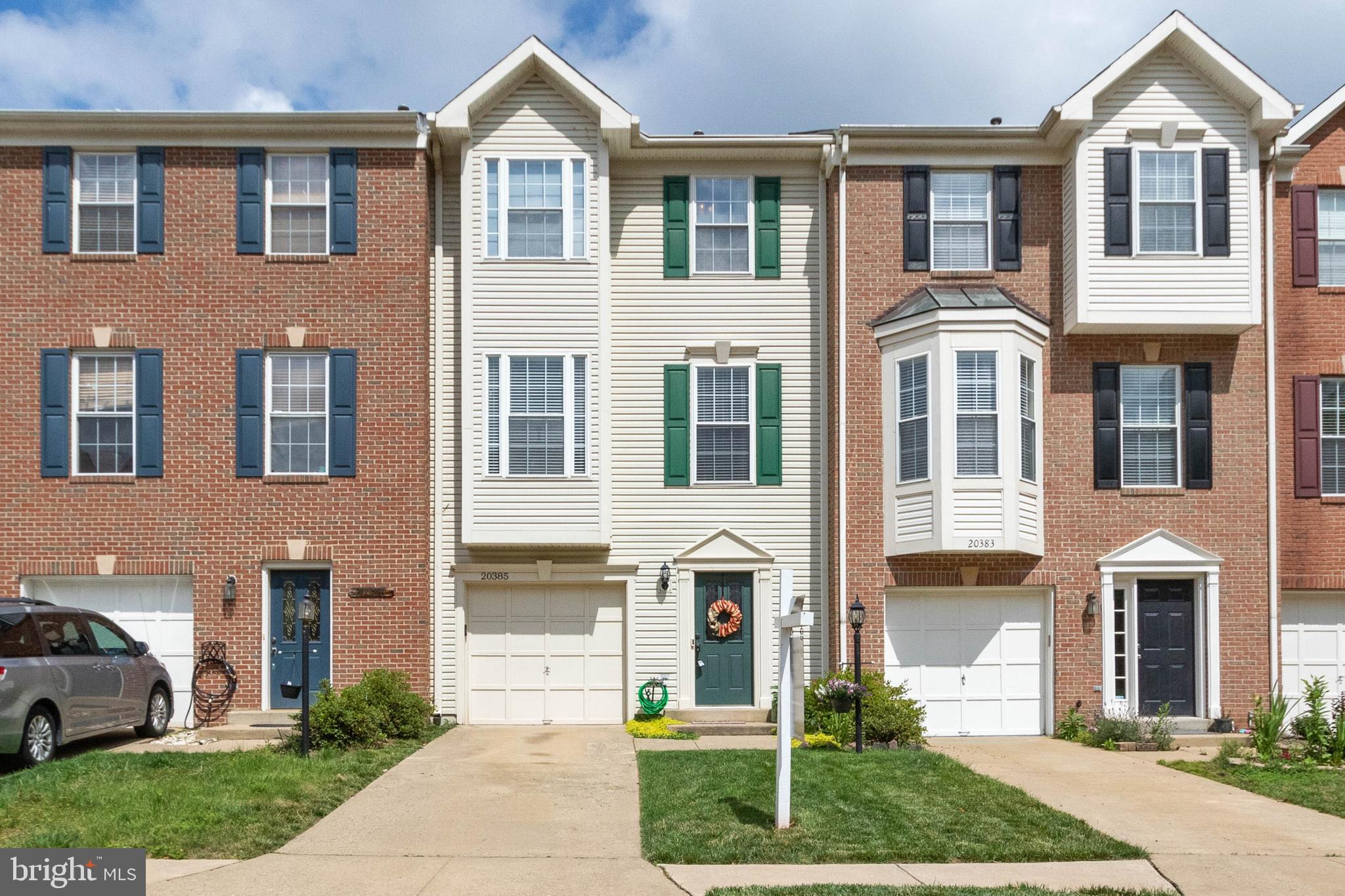 20385 Farmgate Terrace Ashburn, VA 20147 - Photo 1 of 27 a front view of a house with a yard and trees