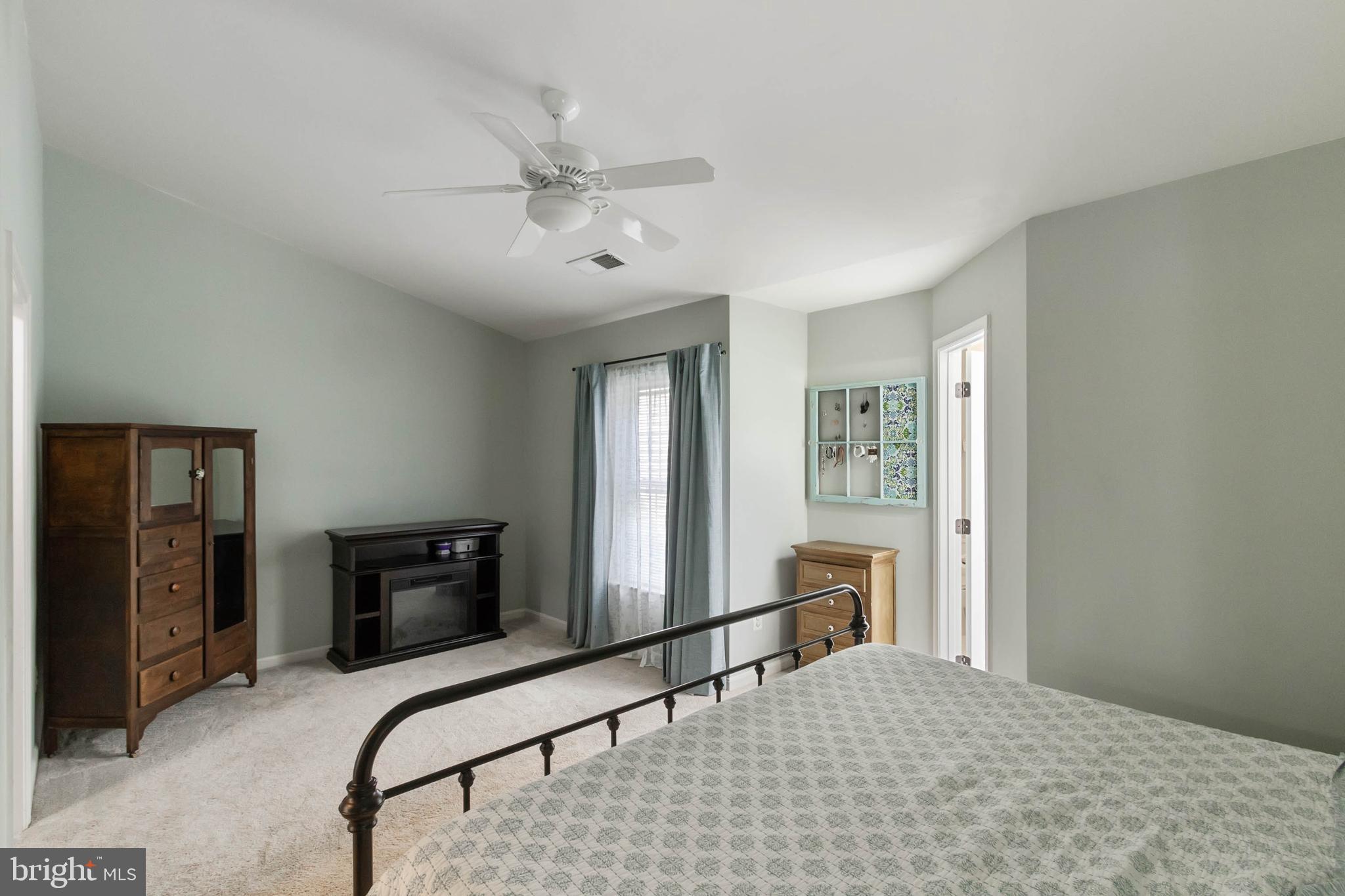 20385 Farmgate Terrace Ashburn, VA 20147 - Photo 12 of 27 a bedroom with a bed flat screen tv and dresser