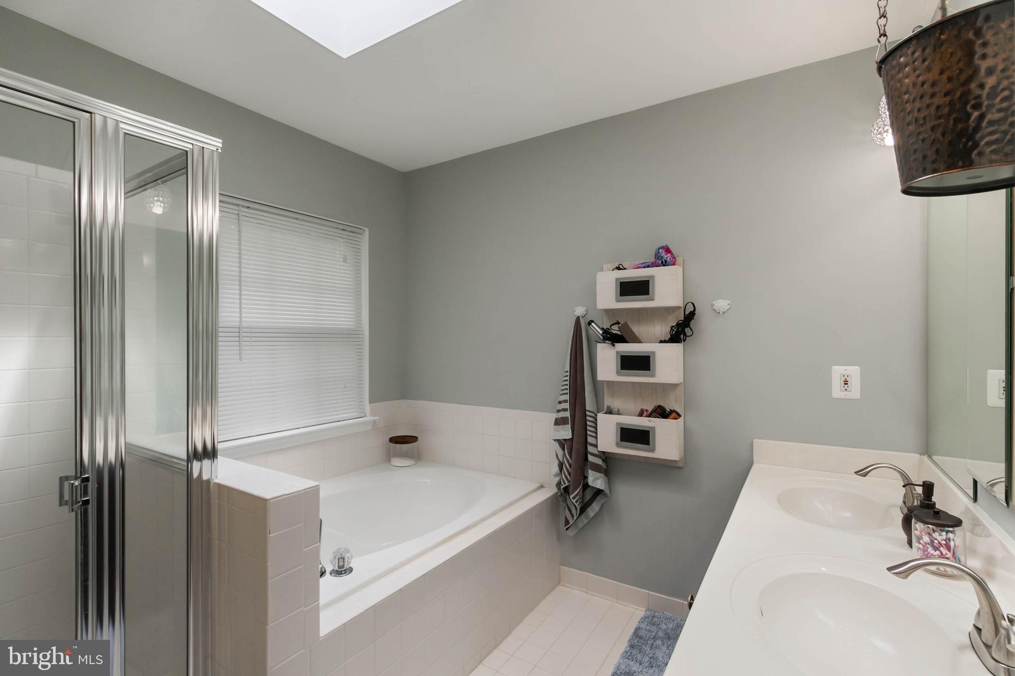 20385 Farmgate Terrace Ashburn, VA 20147 - Photo 13 of 27 a bathroom with a tub and a sink